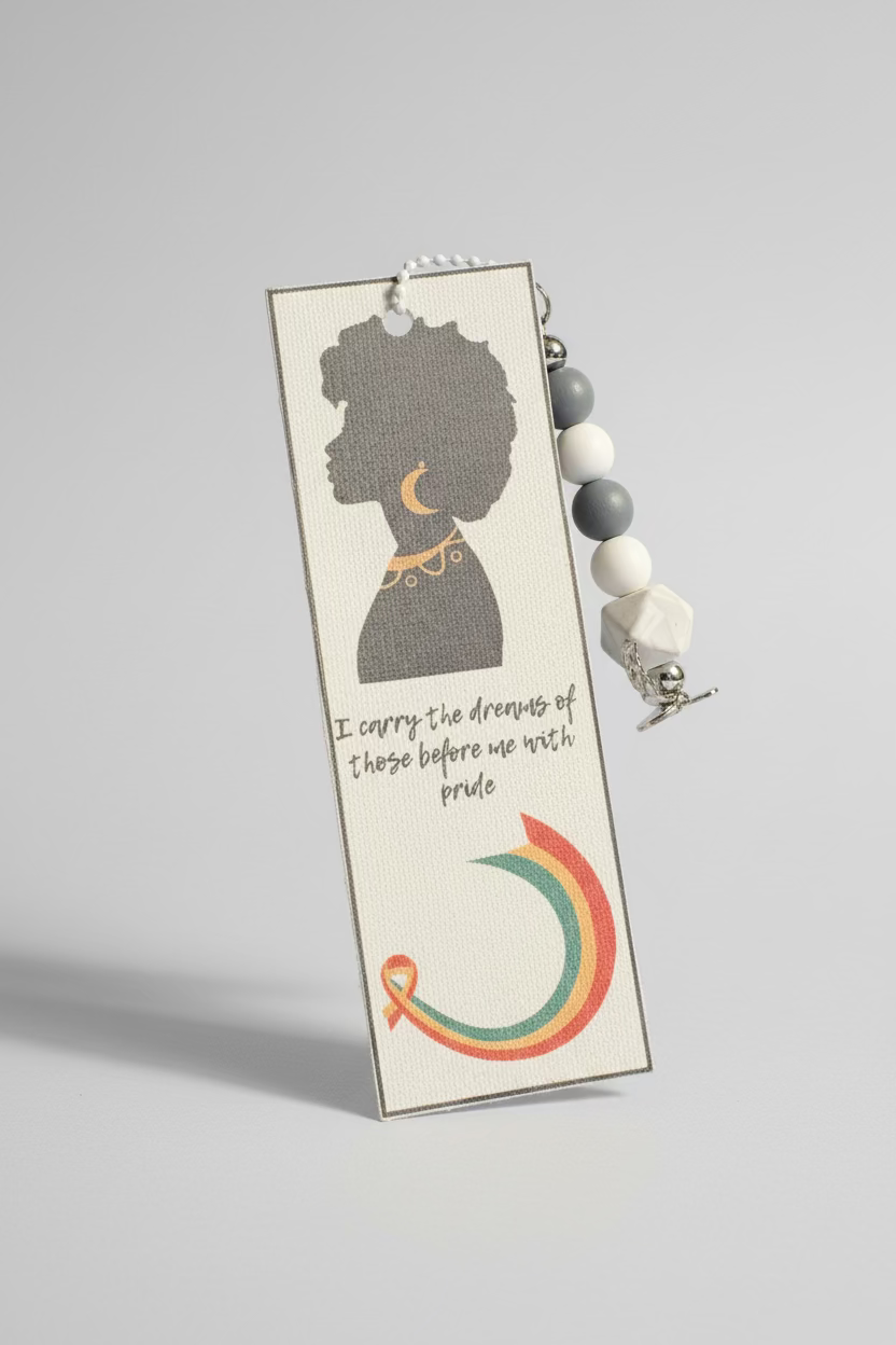 Bookmark with silhouette and rainbow design on a textured surface