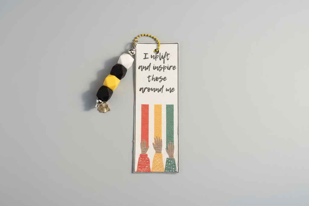 Bookmark with text and colorful hands design on a black background with visible text.