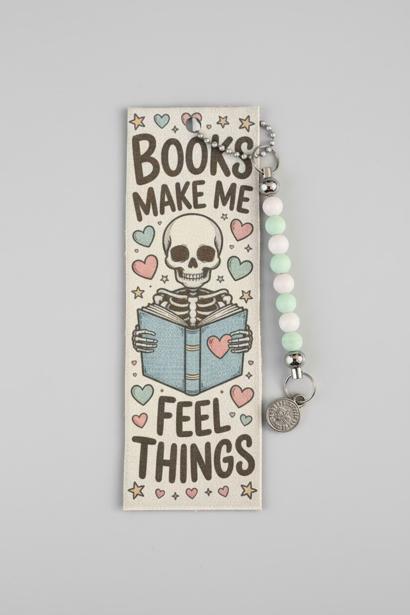 Bookmark with skeleton holding a book and text 'Books make me feel things' on a black background.