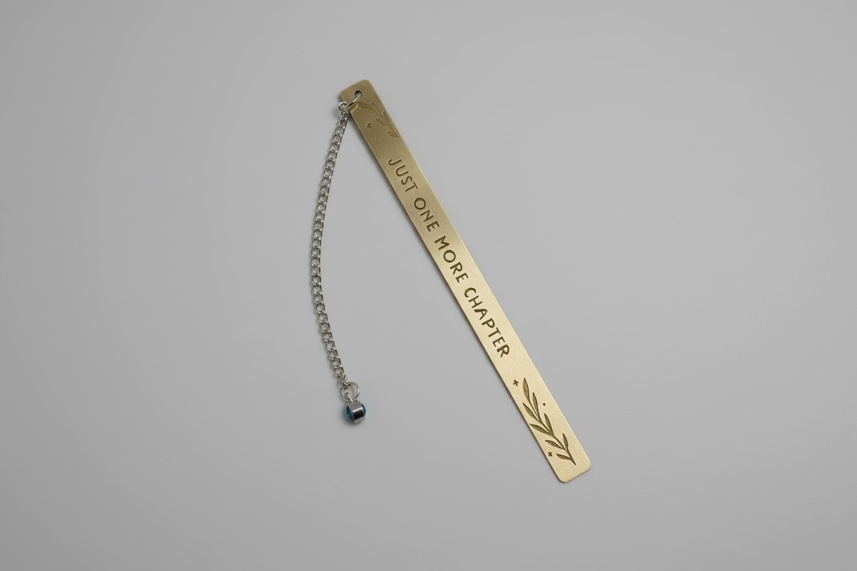 Metal bookmark with chain and engraved text on a white background