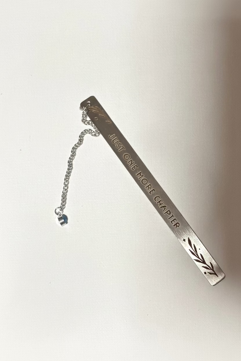 Metal bookmark with 'Just One More Chapter' text on a white background