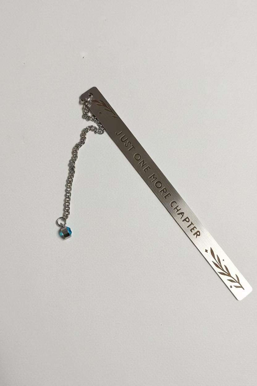 Metal bookmark with 'Just One More Chapter' text on a white background